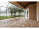 Spacious screened patio with brick flooring and access to the backyard at 5543 Grey Hawk Ln, Lakeland, FL 33810