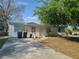 Modest one-story home featuring a front yard, driveway, and simple landscaping at 598 E Highland Ave, Clermont, FL 34711