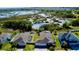 An aerial view of beautiful homes with solar panels with a large pond and lots of nature and greenery in the backyard at 607 Black Eagle Dr, Groveland, FL 34736