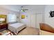 Cozy bedroom with carpet flooring, neutral paint, closet, a large window, and a ceiling fan at 607 Black Eagle Dr, Groveland, FL 34736