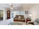 Living room with couch and a vintage grandfather clock near patio door at 607 Black Eagle Dr, Groveland, FL 34736