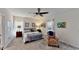 Spacious main bedroom featuring large windows, neutral paint, carpet flooring, and a ceiling fan at 607 Black Eagle Dr, Groveland, FL 34736