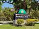 View of the Ronald Sefton Gaffney Memorial Park sign with trees, greenery, and the American flag at 607 Black Eagle Dr, Groveland, FL 34736