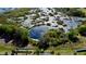 Aerial view of beautiful pond surrounded by lush greenery in community at 607 Black Eagle Dr, Groveland, FL 34736