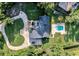 Aerial shot of property showcasing the home, pool, circular driveway, and manicured landscaping at 6115 Linneal Beach Dr, Apopka, FL 32703