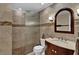 Neutral bathroom with a tiled shower, custom vanity with sink, and tiled flooring at 6115 Linneal Beach Dr, Apopka, FL 32703