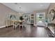 Inviting dining room with hardwood floors, a chandelier, and access to outdoor views at 6115 Linneal Beach Dr, Apopka, FL 32703