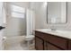 Bright bathroom features a tub with shower, vanity with a marble countertop, and white tiled walls at 6155 Hedgesparrows Ln, Sanford, FL 32771