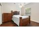 Bedroom with a wood-framed bed, ceiling fan, window, and dresser on a hardwood floor at 6155 Hedgesparrows Ln, Sanford, FL 32771