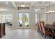 Elegant dining room featuring tile floors, large windows, and decorative lighting at 6155 Hedgesparrows Ln, Sanford, FL 32771