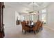 Open dining room showcasing coffered ceiling, tile floor, and elegant furnishings at 6155 Hedgesparrows Ln, Sanford, FL 32771