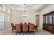 Well-lit dining room features a coffered ceiling, chandelier, and large windows at 6155 Hedgesparrows Ln, Sanford, FL 32771