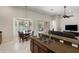 Kitchen and dining area feature modern appliances and sliding doors to pool area at 6155 Hedgesparrows Ln, Sanford, FL 32771