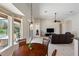 Open-concept living room with tile flooring, a ceiling fan, a sliding door to the pool, and a dining area at 6155 Hedgesparrows Ln, Sanford, FL 32771