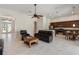 Open-concept living room with dark leather furniture and an open view to the kitchen at 6155 Hedgesparrows Ln, Sanford, FL 32771