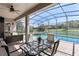 Inviting screened-in patio featuring pool and spa with a beautiful lake view at 6155 Hedgesparrows Ln, Sanford, FL 32771