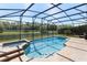 Sparkling pool and spa area with screened enclosure, offering a private oasis for relaxation at 6155 Hedgesparrows Ln, Sanford, FL 32771