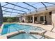 Screened pool with integrated spa and outdoor seating area perfect for entertaining at 6155 Hedgesparrows Ln, Sanford, FL 32771