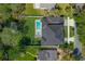 Top down aerial view of the two story home with backyard pool and lush green yard at 640 Old Horatio Ave, Maitland, FL 32751