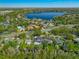 Aerial view of the two story home from the street with a lake in the background at 640 Old Horatio Ave, Maitland, FL 32751