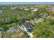 Stunning aerial view of the luxury two story home with mature trees and lush landscaping at 640 Old Horatio Ave, Maitland, FL 32751