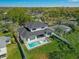 Backyard view of a beautiful two story home with a pool, jacuzzi, and lounge chairs at 640 Old Horatio Ave, Maitland, FL 32751