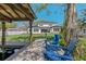 Beautiful backyard with a modern house, a boat dock, and blue Adirondack chairs overlooking the canal at 640 Old Horatio Ave, Maitland, FL 32751