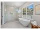 Beautiful bathroom featuring a large soaking tub, walk-in shower, and natural lighting at 640 Old Horatio Ave, Maitland, FL 32751