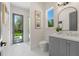 Beautiful bathroom featuring white tile floor, vanity with drawers, shower, and window with outdoor view at 640 Old Horatio Ave, Maitland, FL 32751