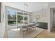 Elegant dining room featuring a sleek marble table, modern chairs, and a large window overlooking the backyard at 640 Old Horatio Ave, Maitland, FL 32751