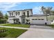 Inviting home featuring a manicured lawn, stylish front door, and a spacious three-car garage at 640 Old Horatio Ave, Maitland, FL 32751