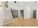 Bright foyer with a staircase, modern front door, and an open view into the home office at 640 Old Horatio Ave, Maitland, FL 32751