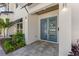 Charming entryway boasting a vibrant blue door, modern hardware, and lush landscaping accents at 640 Old Horatio Ave, Maitland, FL 32751