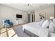 Sun-filled main bedroom features a decorative rug, hardwood flooring and calming color palette at 640 Old Horatio Ave, Maitland, FL 32751