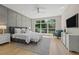 Bright main bedroom featuring a panel wall, a large window, and a TV at 640 Old Horatio Ave, Maitland, FL 32751