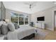 Bright main bedroom featuring a large window, dresser, and TV at 640 Old Horatio Ave, Maitland, FL 32751