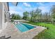 Beautiful pool area with in-pool loungers, a spa, and serene backyard setting at 640 Old Horatio Ave, Maitland, FL 32751