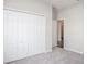 Bedroom view featuring a folding closet and doorway with wood-look flooring in hall at 6471 Octave St, Mascotte, FL 34753