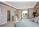 This main bedroom features a tray ceiling, walk-in closet, and large windows at 6471 Octave St, Mascotte, FL 34753