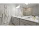 Bathroom featuring a glass shower, double sink vanity, and a large mirror at 652 Orange Belt Loop, Winter Garden, FL 34787