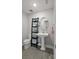 Modern half-bathroom featuring a pedestal sink, an oval mirror, and wood-look tile floors at 652 Orange Belt Loop, Winter Garden, FL 34787