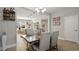 Stylish dining area connected to a modern kitchen with wine storage and open shelves at 652 Orange Belt Loop, Winter Garden, FL 34787