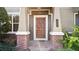 Inviting front door featuring brick and contemporary accents at 652 Orange Belt Loop, Winter Garden, FL 34787