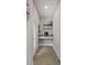 Hallway nook featuring a desk, floating shelves, and natural lighting from the adjacent glass paneled door at 652 Orange Belt Loop, Winter Garden, FL 34787