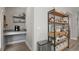 Hallway nook featuring a desk, floating shelves, and a wooden storage shelf with metal frame at 652 Orange Belt Loop, Winter Garden, FL 34787