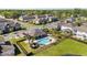 An aerial shot of a community swimming pool with a gazebo, sun loungers, landscaping, and iron fence at 652 Orange Belt Loop, Winter Garden, FL 34787