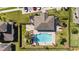 Aerial view of community swimming pool surrounded by manicured landscaping and wrought iron fence at 652 Orange Belt Loop, Winter Garden, FL 34787