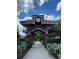 Welcome to Winter Garden, a charming brick entrance with a clock under a bright blue cloudy sky at 652 Orange Belt Loop, Winter Garden, FL 34787