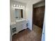 Updated bathroom featuring a vanity with marble countertop and a tiled walk-in shower at 7847 Golf Paradise Way, Clermont, FL 34711