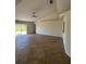 Spacious living room featuring ceramic tile flooring, a ceiling fan and sliding glass doors to the outside at 7847 Golf Paradise Way, Clermont, FL 34711